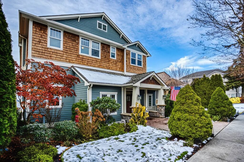 Exterior house with painted siding and trim in winter by a painter in Ashland, MA