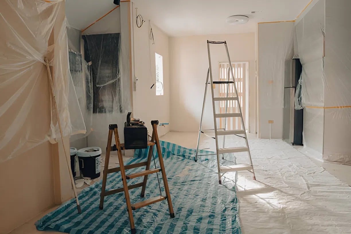 Interior prep work with ladders, plastic covering, and protected floors by an interior painter in Hopkinton, MA