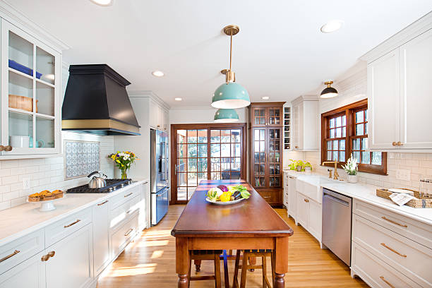 Bright white kitchen walls with crisp white trims and black range hood accents by a painting company in Southborough, MA