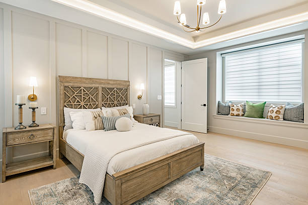 Luxury bedroom with neutral wall colors and custom trim painted by an interior painter in Sherborn, MA