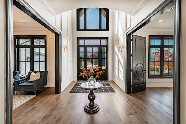 Foyer with freshly painted white walls, black trim, and modern finishes by a painting company in Dover, MA.