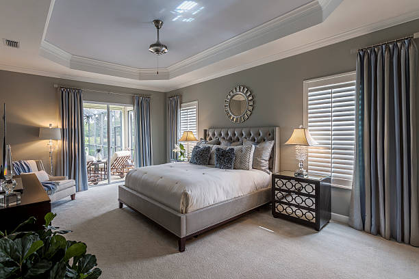 Elegant gray bedroom with tray ceiling and trim details by an interior painter in Sherborn, MA