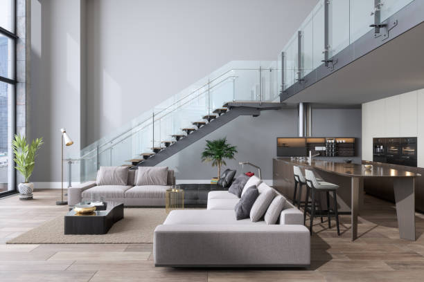 Living room with freshly painted walls, glass staircase, and neutral finishes by a painting company in Dover, MA.