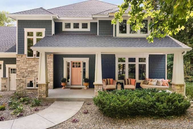Blue-gray home exterior with stone accents and clean finishes by a house painter in Franklin, MA