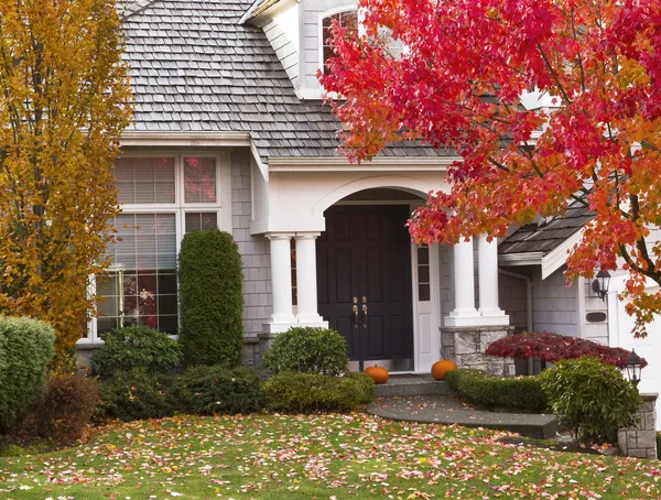 Home with crisp white trim and neutral exterior finishes by a painter in Westborough, MA.