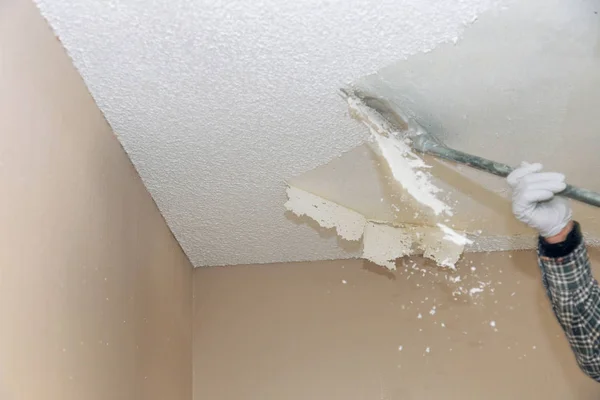 Professional popcorn ceiling removal by an interior painter in Ashland, MA preparing the surface for a smooth finish.